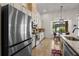 Modern kitchen with stainless steel appliances, white cabinets, and a view of the outdoor patio and dining area at 2456 Northumbria Dr, Sanford, FL 32771