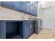 Well-organized laundry room with modern washer and dryer, and blue cabinets at 2456 Northumbria Dr, Sanford, FL 32771