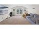 Bright living room featuring a large window, an armchair and a striped couch at 2456 Northumbria Dr, Sanford, FL 32771