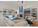 Stylish living area with a fireplace, built-in shelving, and sliding glass doors leading to the outdoor pool area at 2456 Northumbria Dr, Sanford, FL 32771