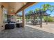 Spacious outdoor patio with comfortable seating, outdoor kitchen, and dining area under a pergola at 2456 Northumbria Dr, Sanford, FL 32771