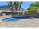Inviting kidney-shaped pool with stone surround and well-maintained landscaping for relaxing outdoor enjoyment at 2456 Northumbria Dr, Sanford, FL 32771