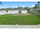 Spacious backyard featuring a manicured lawn and surrounded by fencing at 2626 Coachman Dr, Deltona, FL 32738