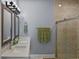 Modern bathroom featuring dual sinks, framed mirrors, and a glass-enclosed shower at 2626 Coachman Dr, Deltona, FL 32738