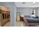 Bedroom with a walk-in closet, tile flooring, neutral walls, and natural light at 2626 Coachman Dr, Deltona, FL 32738