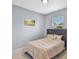 Cozy bedroom featuring neutral tones, an upholstered headboard, and tile flooring at 2626 Coachman Dr, Deltona, FL 32738