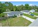 Newer home with a well manicured lawn, concrete drive and mature palm trees at 2626 Coachman Dr, Deltona, FL 32738