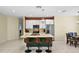 Open kitchen with stainless steel appliances, center island with seating, and adjacent dining area at 2626 Coachman Dr, Deltona, FL 32738