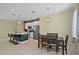 Open-concept kitchen with stainless appliances, an island with seating, and a dining area at 2626 Coachman Dr, Deltona, FL 32738