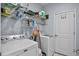 Laundry room featuring a washer, dryer, wire shelving, and a door to an exterior at 2626 Coachman Dr, Deltona, FL 32738