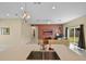 Open-concept living room features tile flooring, neutral paint, and seamless flow to the kitchen at 2626 Coachman Dr, Deltona, FL 32738