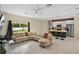 Open-concept living room features tile flooring and flows into the kitchen with breakfast bar seating at 2626 Coachman Dr, Deltona, FL 32738