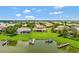 Scenic aerial view of a waterfront property with lush landscaping, private docks, and serene lake views at 2631 Captains Ct, Kissimmee, FL 34746