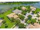 Stunning aerial view of home, showcasing lush landscaping and lake access with private dock at 2631 Captains Ct, Kissimmee, FL 34746