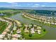 Expansive aerial of the community featuring waterfront homes and lush green landscapes by a lake at 2631 Captains Ct, Kissimmee, FL 34746