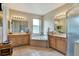 Spacious bathroom features dual vanities, a garden tub, and enclosed shower, perfect for a spa-like experience at 2631 Captains Ct, Kissimmee, FL 34746