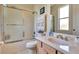 Neat bathroom features a shower-tub combo with sliding glass doors, vanity, and matching fixtures at 2631 Captains Ct, Kissimmee, FL 34746