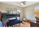 Comfortable bedroom features a bunk bed, a ceiling fan, and natural light from a large window at 2631 Captains Ct, Kissimmee, FL 34746