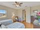 Cozy bedroom with two twin beds, large window, ceiling fan, and adjoining ensuite bathroom at 2631 Captains Ct, Kissimmee, FL 34746
