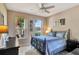 Comfortable bedroom with tile flooring, ceiling fan, and natural light from two windows at 2631 Captains Ct, Kissimmee, FL 34746