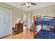 Neutral bedroom features a bunk bed, ceiling fan, natural light, and direct access to other areas of the home at 2631 Captains Ct, Kissimmee, FL 34746