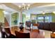 Formal dining room features wood table, chandelier lighting, and staircase to the left at 2631 Captains Ct, Kissimmee, FL 34746