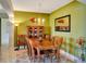 Formal dining room featuring a wood table and chairs, modern lighting, and decor at 2631 Captains Ct, Kissimmee, FL 34746