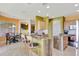 Open kitchen features marble countertops, barstool seating, and stainless steel appliances at 2631 Captains Ct, Kissimmee, FL 34746