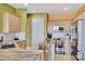 Another view of the kitchen with modern appliances and an island featuring marble countertop at 2631 Captains Ct, Kissimmee, FL 34746
