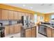 Large kitchen featuring stainless steel appliances, central island, and ample counter space at 2631 Captains Ct, Kissimmee, FL 34746