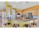 Modern kitchen with breakfast bar, marble countertops, and stainless steel appliances at 2631 Captains Ct, Kissimmee, FL 34746