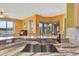 Close-up of the kitchen sink and marble countertops, highlighting the natural light and finishes at 2631 Captains Ct, Kissimmee, FL 34746