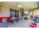 Inviting covered lanai featuring a ceiling fan and comfortable seating for outdoor relaxation and entertaining at 2631 Captains Ct, Kissimmee, FL 34746