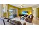 This comfortable living room features tile floors, neutral colors, and access to the outdoor patio at 2631 Captains Ct, Kissimmee, FL 34746