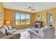 Serene living room with large window showcasing a waterfront view, ceiling fan, and comfortable seating at 2631 Captains Ct, Kissimmee, FL 34746
