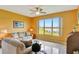 Living room with waterfront views, comfortable sofas, a ceiling fan, and tile flooring at 2631 Captains Ct, Kissimmee, FL 34746