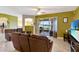 Spacious living room leads to outdoor patio, offering views of the lake and surrounding nature at 2631 Captains Ct, Kissimmee, FL 34746