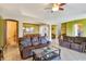 Open-concept living room with view to the formal dining room and the stairs leading up to the second floor at 2631 Captains Ct, Kissimmee, FL 34746