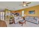 Inviting living room featuring tile floors, comfortable seating, and a breakfast bar looking into the kitchen at 2631 Captains Ct, Kissimmee, FL 34746