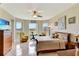 Large main bedroom with water views, natural light, tile floor, and a seating area at 2631 Captains Ct, Kissimmee, FL 34746