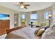 Bright main bedroom with water view, ceiling fan, and a private balcony entrance for relaxing outdoors at 2631 Captains Ct, Kissimmee, FL 34746