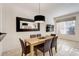 Dining room with a modern light fixture, table for six, and neutral decor at 2745 Corvette Ln, Kissimmee, FL 34746