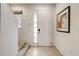 Bright foyer featuring tile flooring, stairs, a front door with sidelight, and a framed artwork at 2745 Corvette Ln, Kissimmee, FL 34746