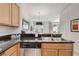 Kitchen view showcasing stainless steel dishwasher, granite countertops, and access to the living area at 2745 Corvette Ln, Kissimmee, FL 34746