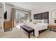 Bright main bedroom with a large bed, modern furniture, and access to a private balcony at 2745 Corvette Ln, Kissimmee, FL 34746