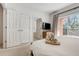 Relaxing bedroom with a king bed, balcony access, and ensuite bathroom through open doorway at 2745 Corvette Ln, Kissimmee, FL 34746