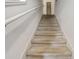 Carpeted staircase with white walls and handrail leading to the upper level of the home at 2745 Corvette Ln, Kissimmee, FL 34746