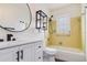 Updated bathroom with modern vanity, large mirror, and a tub with a bright yellow tiled wall at 2893 S Osceola Ave # E6, Orlando, FL 32806