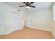 Bedroom with hardwood floors, a modern ceiling fan, closet doors, and a bright window at 2893 S Osceola Ave # E6, Orlando, FL 32806