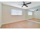 Spacious bedroom with hardwood floors, a large window with blinds, and a full mirrored wall at 2893 S Osceola Ave # E6, Orlando, FL 32806